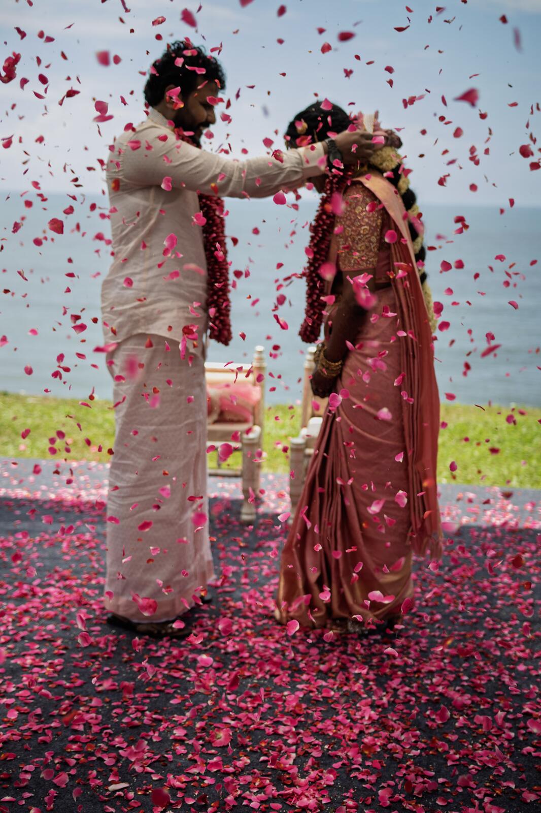 Sakthi and Manju under a shower of petals at their wedding