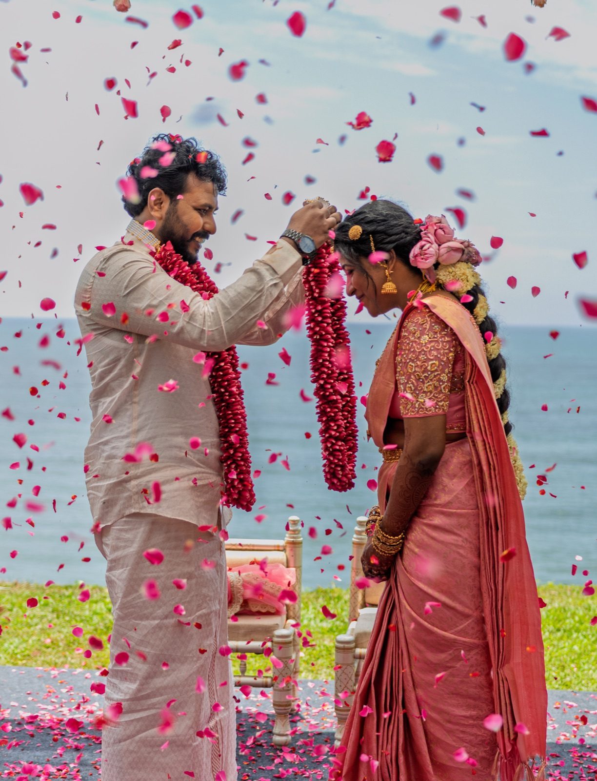 Sakthi garlanding Manju under a shower of rose petals at their wedding